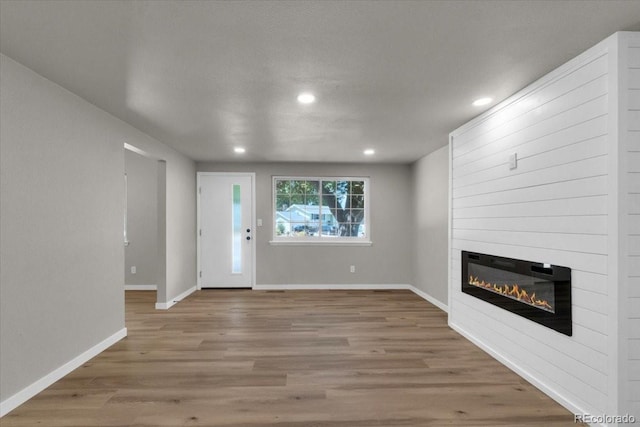 10 Juneau Pl, Longmont, CO 80504 - unfurnished living room with a fireplace, recessed lighting, and wood finished floors