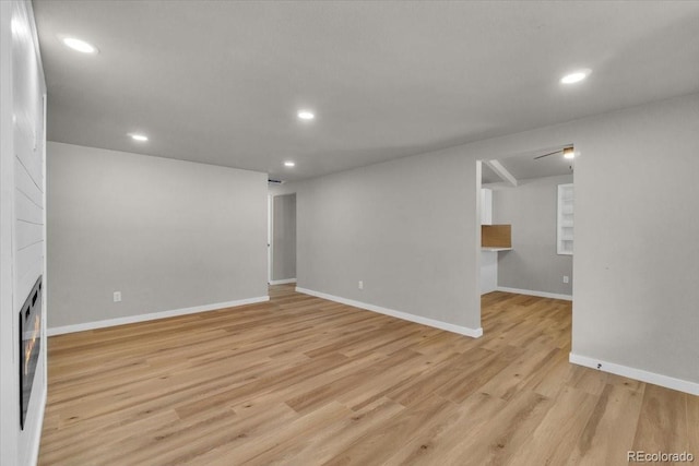 10 Juneau Pl, Longmont, CO 80504 - unfurnished living room with light wood-type flooring, recessed lighting, and a large fireplace