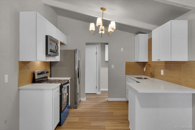 10 Juneau Pl, Longmont, CO 80504 - kitchen with stainless steel appliances, white cabinetry, light wood-style flooring, tasteful backsplash, and vaulted ceiling