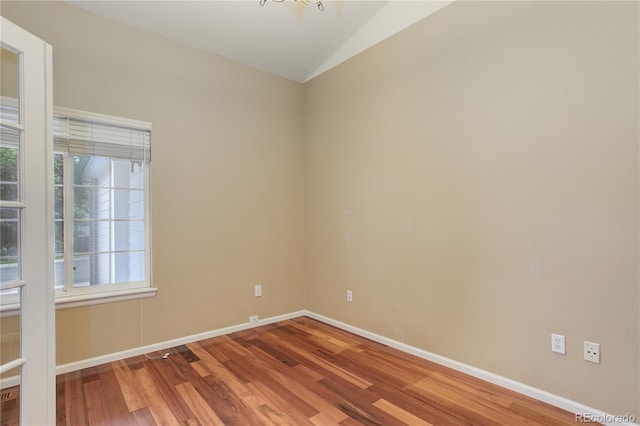 354 Willowick Cir, Highlands Ranch, CO 80129 - unfurnished room featuring lofted ceiling, wood finished floors, healthy amount of natural light, and baseboards