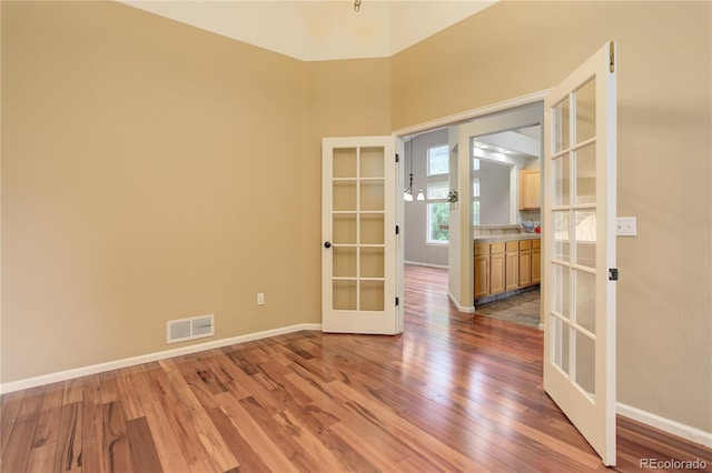 354 Willowick Cir, Highlands Ranch, CO 80129 - empty room with french doors, wood finished floors, and baseboards