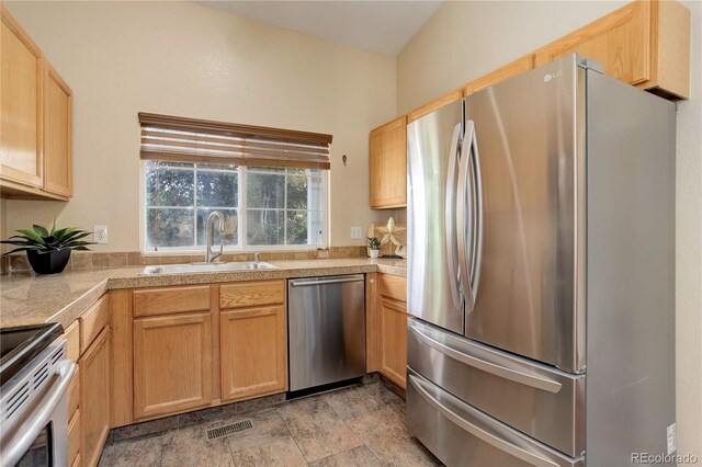 354 Willowick Cir, Highlands Ranch, CO 80129 - kitchen with appliances with stainless steel finishes, a sink, tile counters, stone finish flooring, and light brown cabinetry
