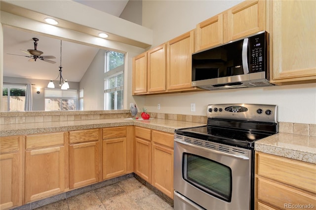 354 Willowick Cir, Highlands Ranch, CO 80129 - kitchen featuring stainless steel appliances, lofted ceiling, light brown cabinets, tile countertops, and a ceiling fan