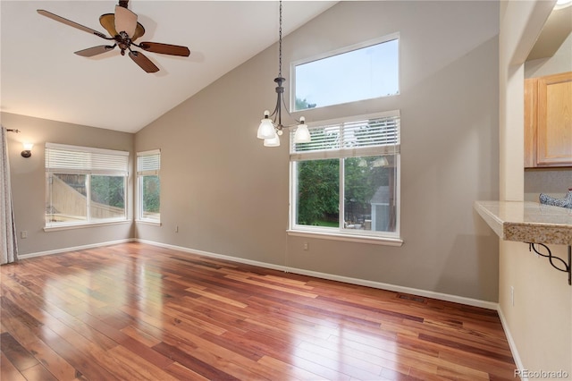 354 Willowick Cir, Highlands Ranch, CO 80129 - unfurnished dining area with healthy amount of natural light, high vaulted ceiling, light wood finished floors, and ceiling fan