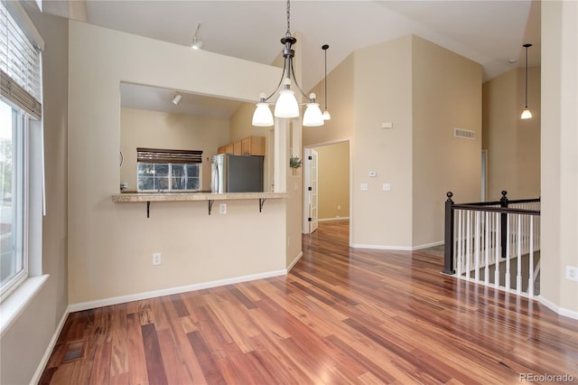 354 Willowick Cir, Highlands Ranch, CO 80129 - empty room with wood finished floors, high vaulted ceiling, and baseboards