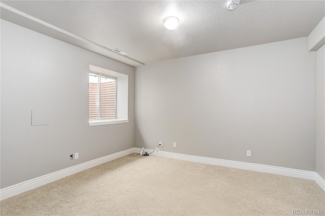 354 Willowick Cir, Highlands Ranch, CO 80129 - spare room with light carpet, baseboards, a smoke detector, and a textured ceiling