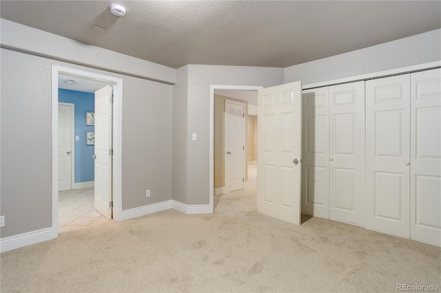 354 Willowick Cir, Highlands Ranch, CO 80129 - unfurnished bedroom featuring carpet floors, a textured ceiling, ensuite bathroom, baseboards, and a closet
