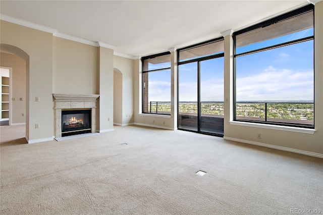 unfurnished living room with light colored carpet and ornamental molding