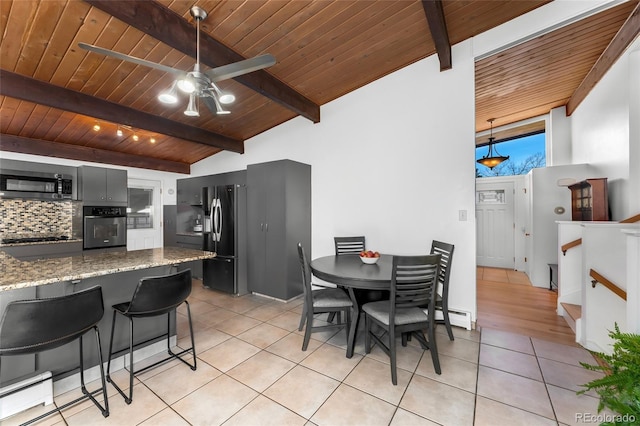 kitchen featuring light stone countertops, appliances with stainless steel finishes, light tile patterned floors, and wooden ceiling