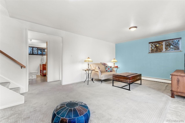 living area featuring baseboard heating and carpet floors