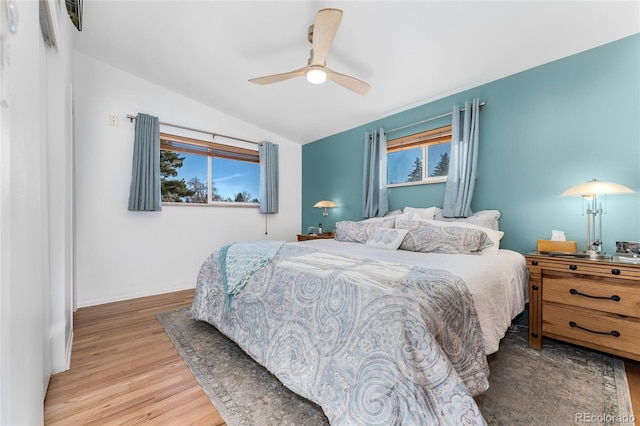 bedroom featuring ceiling fan, light hardwood / wood-style floors, and vaulted ceiling