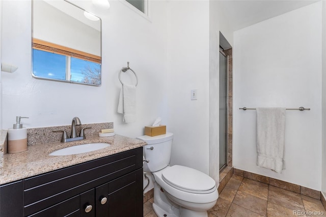 bathroom with an enclosed shower, vanity, and toilet