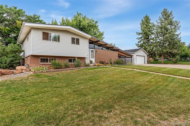 view of front of house featuring a garage, an outbuilding, and a front yard