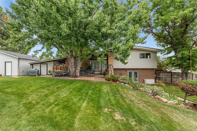 back of property featuring a yard, a patio, and french doors