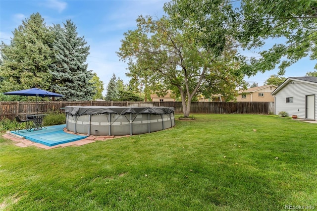 view of yard with a covered pool