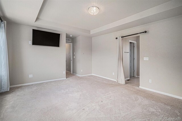 17187 E Cedar Gulch Dr, Parker, CO 80134 - spare room with a raised ceiling, light colored carpet, and a barn door