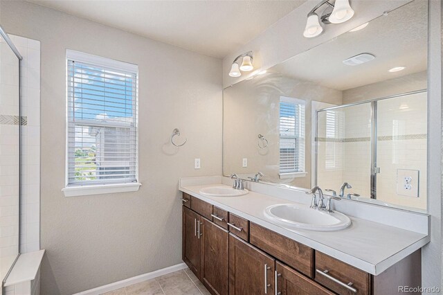 17187 E Cedar Gulch Dr, Parker, CO 80134 - full bathroom with healthy amount of natural light, double vanity, tiled shower, and tile patterned flooring