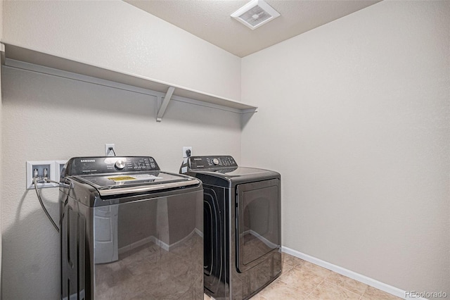 17187 E Cedar Gulch Dr, Parker, CO 80134 - laundry room featuring washer and clothes dryer and light tile patterned floors
