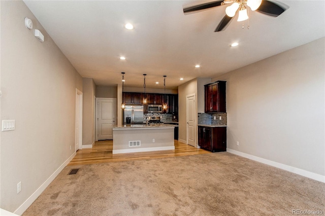 767 Robert St, Longmont, CO 80503 - kitchen featuring stainless steel appliances, light colored carpet, recessed lighting, tasteful backsplash, and a ceiling fan