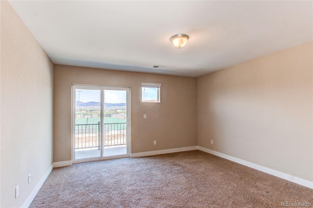 767 Robert St, Longmont, CO 80503 - carpeted spare room featuring baseboards
