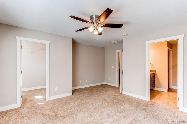 767 Robert St, Longmont, CO 80503 - unfurnished bedroom with light carpet, a walk in closet, baseboards, ceiling fan, and a closet
