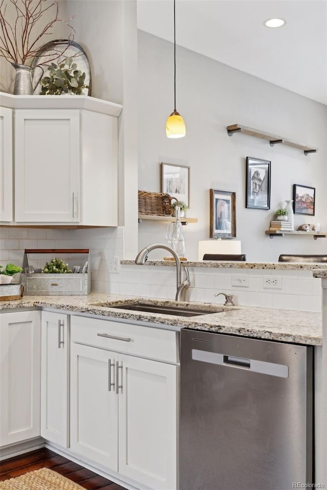 kitchen with dishwasher, white cabinetry, tasteful backsplash, sink, and hanging light fixtures