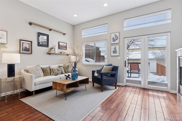 living room featuring a wealth of natural light and dark hardwood / wood-style floors