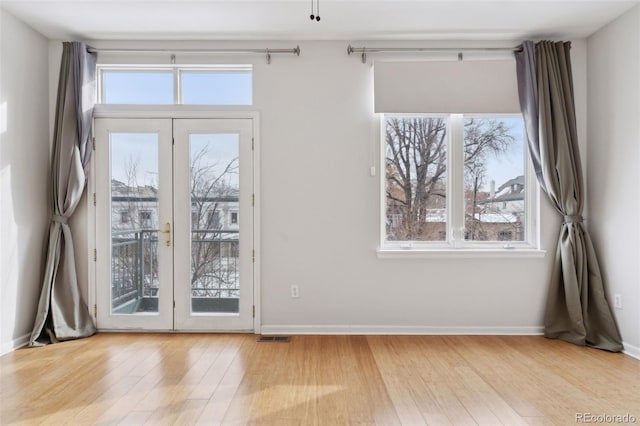 doorway featuring light hardwood / wood-style floors, french doors, and plenty of natural light