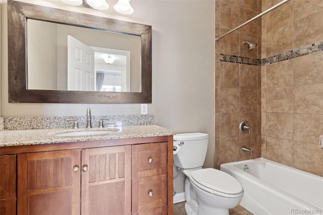 full bathroom with tiled shower / bath combo, vanity, and toilet