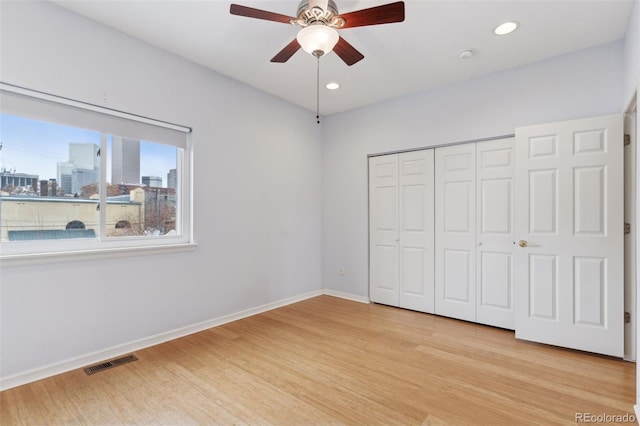 unfurnished bedroom with a closet, ceiling fan, and light hardwood / wood-style floors