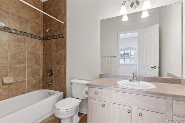 full bathroom with toilet, vanity, tiled shower / bath, and tile patterned flooring