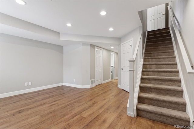 stairway featuring hardwood / wood-style flooring