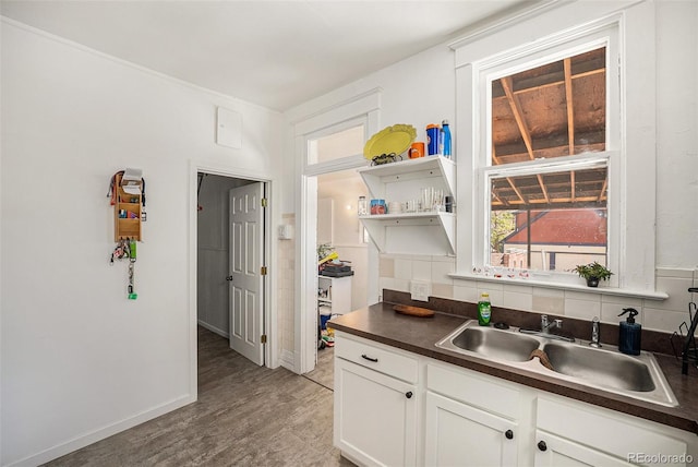 4536 Beach Ct, Denver, CO 80211 - kitchen with a sink, dark countertops, open shelves, and light wood-style flooring