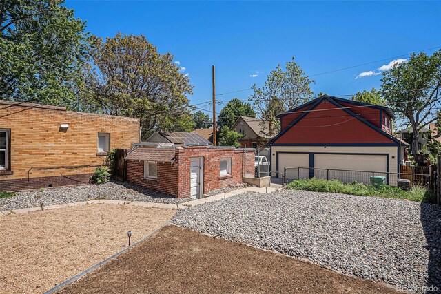 4536 Beach Ct, Denver, CO 80211 - view of side of home featuring an outbuilding, brick siding, and a garage