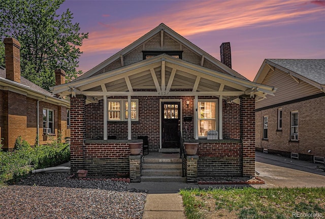 4536 Beach Ct, Denver, CO 80211 - view of front of house featuring a porch, brick siding, and a chimney