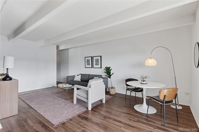 living room featuring wood finished floors, beamed ceiling, and baseboards