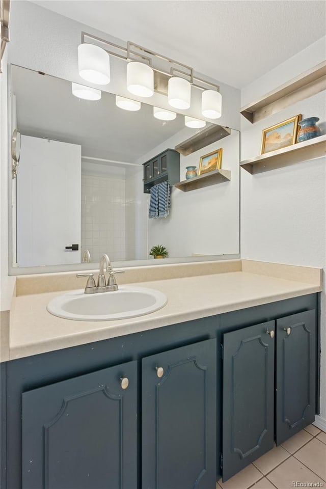full bathroom featuring vanity and tile patterned floors