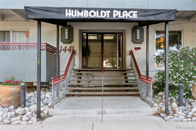 entrance to property with stucco siding