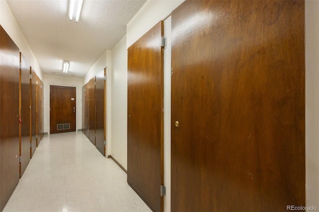 hallway featuring a textured ceiling