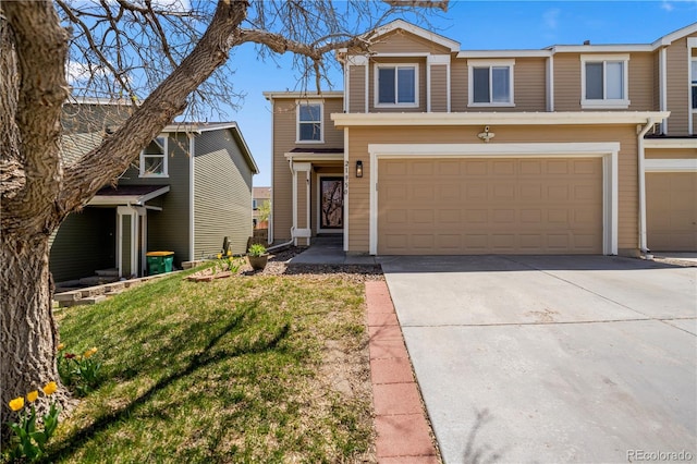 view of front of house with a garage, driveway, and a front yard