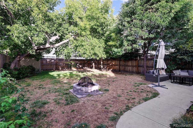 view of yard featuring a patio and a fire pit