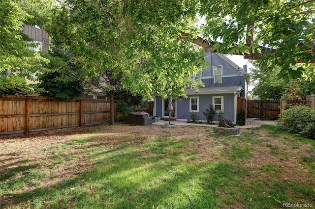 1473 Yates St, Denver, CO 80204 - back of property featuring a fenced backyard, central AC, a patio, a lawn, and an outdoor fire pit