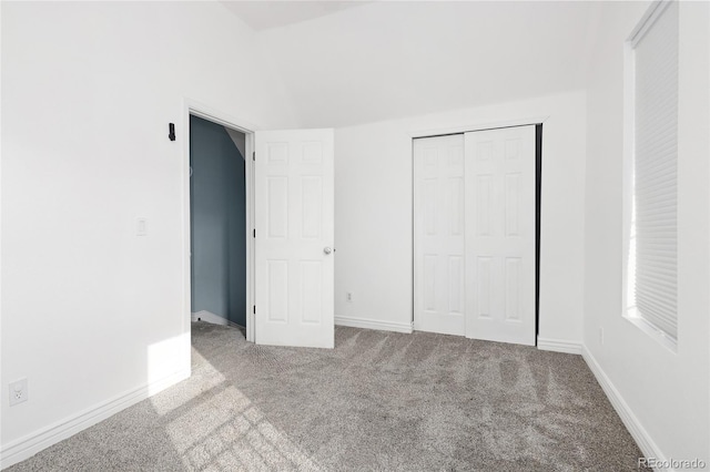 unfurnished bedroom with carpet floors and a closet