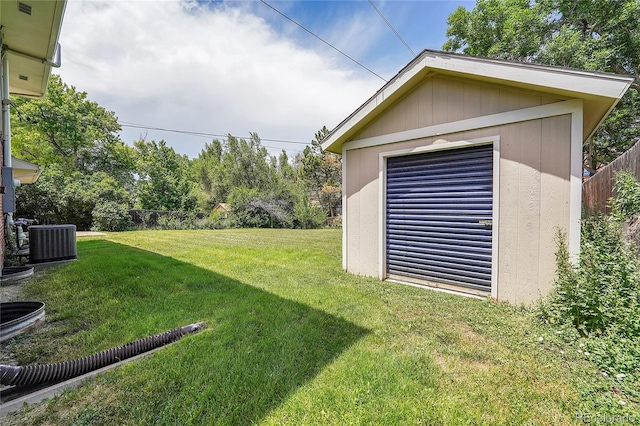 view of yard featuring central AC unit and a storage unit