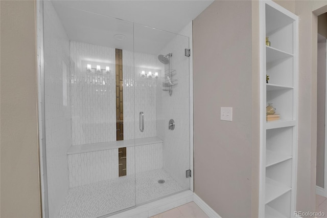 bathroom featuring tile patterned floors, built in features, and walk in shower