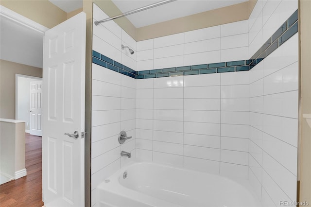 bathroom featuring tiled shower / bath combo and wood-type flooring