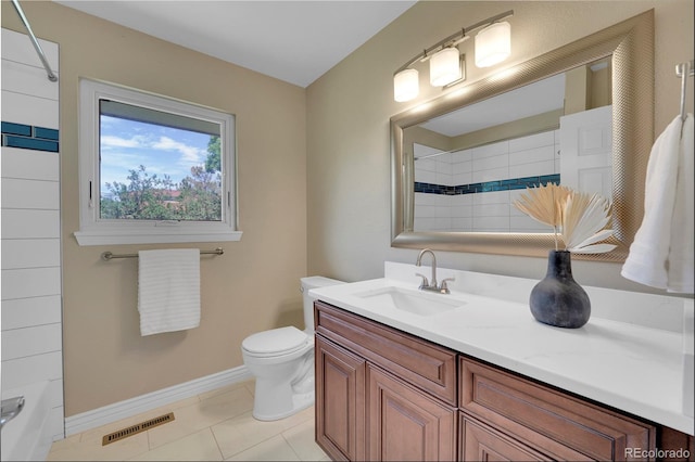 bathroom featuring tile patterned flooring, vanity, and toilet