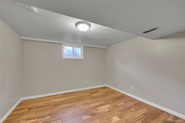 basement with light hardwood / wood-style floors