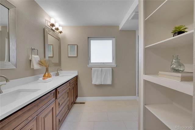 bathroom with tile patterned flooring and vanity