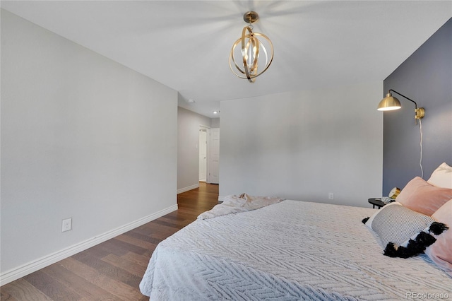 bedroom with dark wood-type flooring and a chandelier